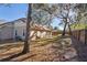 A large, grassy backyard bordered by a wooden fence and mature shade trees draped in spanish moss at 1430 17Th St, Orange City, FL 32763