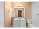 Bathroom features a white vanity with a framed mirror, lighting, and toilet at 1430 17Th St, Orange City, FL 32763