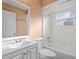 This bathroom features a white vanity, shower-tub combo with tile surround, and a window, creating a clean and functional space at 1430 17Th St, Orange City, FL 32763