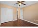 This bedroom features a ceiling fan, wood floors, a closet, and neutral walls, creating a cozy and inviting atmosphere at 1430 17Th St, Orange City, FL 32763