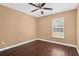 Bedroom featuring sleek flooring, a modern ceiling fan, and a large window for natural light, creating a calming and inviting space at 1430 17Th St, Orange City, FL 32763