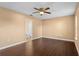 Bedroom featuring wood flooring, a ceiling fan, and an ensuite bathroom, offering comfort and privacy at 1430 17Th St, Orange City, FL 32763