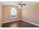 Bright bedroom featuring a modern ceiling fan, sleek wood floors, and a window that allows ample natural light at 1430 17Th St, Orange City, FL 32763
