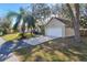 Charming home with a two-car garage, a palm tree, and a well-maintained lawn at 1430 17Th St, Orange City, FL 32763