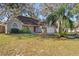 Well-manicured lawn featuring a charming house with an attached garage and a red front door at 1430 17Th St, Orange City, FL 32763