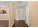 Spacious hallway with hardwood floors leads to the kitchen with light-colored cabinets and modern appliances at 1430 17Th St, Orange City, FL 32763