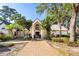 Inviting clubhouse entrance with well-manicured landscaping and brick pathway leading to the front doors at 1465 Farrindon Cir # 1465, Lake Mary, FL 32746