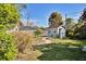 Charming backyard with detached structure, attractive landscaping, and a stone paver path at 1533 Legend Ct, Deltona, FL 32738