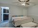 This charming bedroom offers soft carpet, a ceiling fan, and an ensuite bathroom at 1533 Legend Ct, Deltona, FL 32738