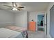 Neutral bedroom featuring a closet, drawers, ceiling fan, and a connecting door to another room at 1533 Legend Ct, Deltona, FL 32738