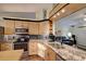 Modern kitchen featuring granite countertops, stainless steel appliances, and ample cabinet space at 1533 Legend Ct, Deltona, FL 32738