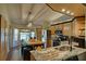 Bright kitchen with an island featuring counter seating, stainless appliances, and wooden cabinets at 1533 Legend Ct, Deltona, FL 32738