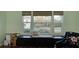 Bright living room featuring a cushioned window seat with views of the backyard at 1533 Legend Ct, Deltona, FL 32738