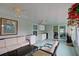 Open sunroom with ceiling fans, sink, and comfortable seating area at 1533 Legend Ct, Deltona, FL 32738