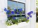 Close up of blue and white flowers overflowing a window box on a white shed at 1533 Legend Ct, Deltona, FL 32738
