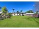 Large backyard with green grass surrounded by a wood fence, and lush foliage at 1551 7Th Ave, Deland, FL 32724
