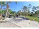 Outdoor living featuring a spacious patio, lush green grass, landscaping, and mature trees at 1551 7Th Ave, Deland, FL 32724