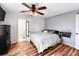 Bedroom featuring wood floors, a ceiling fan and an open ensuite bathroom at 1551 7Th Ave, Deland, FL 32724