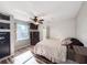 Bright bedroom featuring a ceiling fan, hardwood floors, a window view and a built-in safe at 1551 7Th Ave, Deland, FL 32724