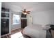 Comfortable bedroom with wood floors, a ceiling fan, and natural light from the window at 1551 7Th Ave, Deland, FL 32724