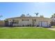 Charming single-story home with a well-manicured lawn and attached garage at 1551 7Th Ave, Deland, FL 32724
