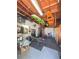 Finished garage with gym equipment, kayaks mounted to ceiling, and rubber tile flooring at 1551 7Th Ave, Deland, FL 32724