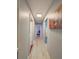 Hallway featuring hardwood floors and neutral walls leading to various rooms in the home at 1551 7Th Ave, Deland, FL 32724