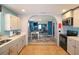 Open kitchen with white cabinets, stainless steel appliances, and an open view to living spaces at 1551 7Th Ave, Deland, FL 32724