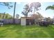 Backyard view featuring a wooden shed and storage area, providing ample space for outdoor equipment at 1551 7Th Ave, Deland, FL 32724