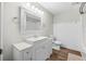 A bright bathroom features a white vanity, classic design, and a tiled shower-tub combo at 171 Moonstone Ct, Port Orange, FL 32129