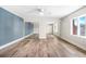 A large bedroom features hardwood floors, a blue accent wall, and mirrored closet doors at 171 Moonstone Ct, Port Orange, FL 32129