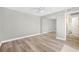 A simple, spacious bedroom features hardwood floors, closet with mirrored doors, and a ceiling fan at 171 Moonstone Ct, Port Orange, FL 32129