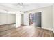 Bright bedroom features wood-look flooring, ceiling fan, and sliding door closet at 171 Moonstone Ct, Port Orange, FL 32129