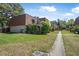 Townhome exterior with walkway, lush landscaping, and manicured lawn at 171 Moonstone Ct, Port Orange, FL 32129