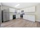 Contemporary kitchen featuring sleek appliances, ample cabinet space, and laminate flooring at 171 Moonstone Ct, Port Orange, FL 32129