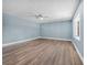 Bright, airy living room with fresh paint, modern laminate flooring, and a ceiling fan at 171 Moonstone Ct, Port Orange, FL 32129