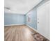 Well-lit living room with modern laminate flooring, a ceiling fan, and a welcoming entry door at 171 Moonstone Ct, Port Orange, FL 32129