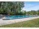Community pool featuring ample space, lounge seating, and lush greenery at 171 Moonstone Ct, Port Orange, FL 32129