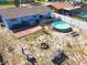 Aerial view of the backyard featuring an above-ground pool and brick patio at 1767 Valencia Ave, Ormond Beach, FL 32174