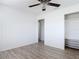 This bedroom has a ceiling fan and a closet with shelves at 1767 Valencia Ave, Ormond Beach, FL 32174