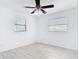 Bedroom with fan, two windows, and wood-look floors at 1767 Valencia Ave, Ormond Beach, FL 32174