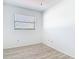This bedroom has wood-look tile flooring and a window for natural light at 1767 Valencia Ave, Ormond Beach, FL 32174