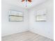 Bedroom with fan, two windows and wood-look floors at 1767 Valencia Ave, Ormond Beach, FL 32174