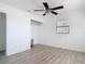 Bright bedroom with fan, wood-look floors and closet with shelving at 1767 Valencia Ave, Ormond Beach, FL 32174