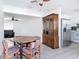 Open concept dining area featuring a wood table and chairs and view into the kitchen and living room at 1767 Valencia Ave, Ormond Beach, FL 32174
