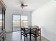 Dining area with wood table, chairs, tile flooring and a sliding glass door to the outside at 1767 Valencia Ave, Ormond Beach, FL 32174