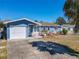 Charming home featuring a garage, landscaping, and covered entry at 1767 Valencia Ave, Ormond Beach, FL 32174