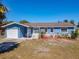 Charming blue single-story home with a well-manicured lawn and attached garage, perfect for comfortable living at 1767 Valencia Ave, Ormond Beach, FL 32174