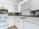 Bright kitchen with white cabinets, stone countertops, stainless steel appliances and modern finishes at 1767 Valencia Ave, Ormond Beach, FL 32174