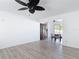 Open living room with light-colored wood flooring, neutral walls and a view of the dining room at 1767 Valencia Ave, Ormond Beach, FL 32174